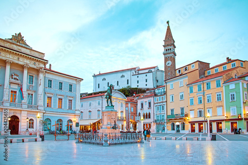 Beautiful street landscape on the central square with a monument and an ancie...