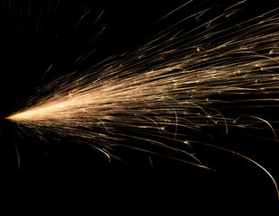 Wall Mural - sparks from red-hot metal, bokeh warm tones, flashes in the dark