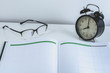 business reminder concept with Appointment book, alarm clock, glasses