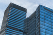 © hallojulie - Modern office building against blue sky.