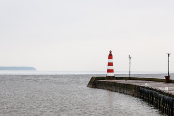 Wall Mural - on a cold winter day, a colorful beacon appears at sea