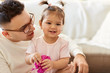 © Syda Productions - family, fatherhood and people concept - close up of happy father and little daughter at home