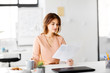 © Syda Productions - business and people concept - businesswoman with papers at working office and drinking coffee