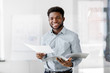 © Syda Productions - business, people and corporate concept - smiling african american businessman with folder at office