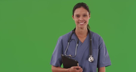 Wall Mural - Happy young medical nurse holding tablet computer for green chromakey composite