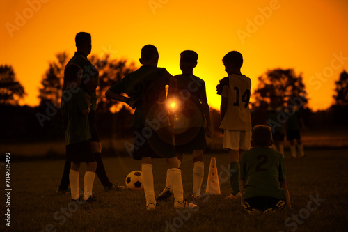 Sunset Soccer. Kids Soccer Football Team on Training with the Coach. Sports  Soccer Practice at Sunset. Soccer Summer Camp for Sporty Children - Buy  this stock photo and explore similar images at