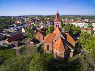 Wall Mural - Aerial view of Wegorzewo town, Poland (former Angerburg, East Prussia). Gothic style St. Peter and St. Paul's Church on the right