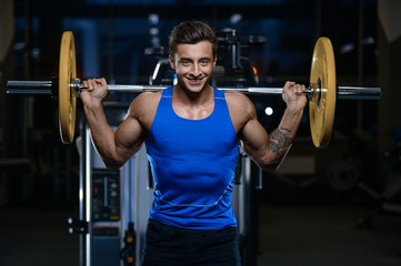 Wall Mural - Handsome model young man workout in gym