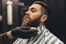 Hipster Young Good Looking Man Visiting Barber Shop. Trendy And Stylish Beard Styling And Cut.