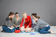© Africa Studio - Group of people practicing CPR on mannequin at first aid class