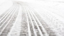 Wheel Tracks On The Road Covered With Snow