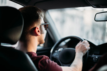 Wall Mural - successful young man driving a car.