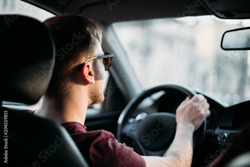 successful young man driving a car. Tableau sur Toile