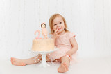 Fototapeta Tulipany - Cake for the second birthday. Portraits with cake. Cake Smash

