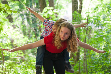 Happy brothers playing outdoors. Making gestures with the arms of flying