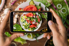 Phone Photography Of Food. Woman Hands Take Photo Of Lunch With Smartphone For Social Media. Fresh Vegetables Salad. Raw Vegan Vegetarian Healthy Dinner 
