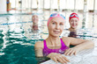 © pressmaster - Healthy mature sportswoman and her friends in swimwear spending time in swimming-pool