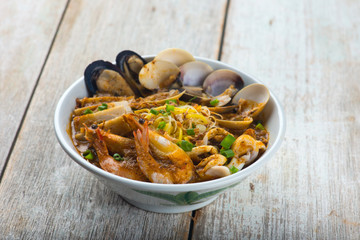 Poster - seafood curry noodle with wood background