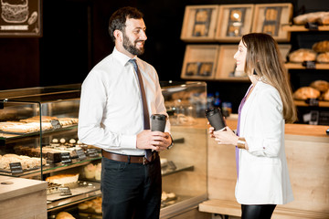 Wall Mural - Business couple talking near the counter of the coffee shop