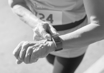 Wall Mural - Senior runner using a fitness tracker