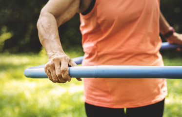 Wall Mural - Senior woman exercising with a hula hoop