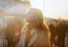 Beautiful Young Blonde Woman Enjoys Sun Beams At Crowdy City Street