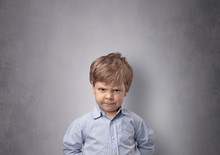 Adorable Little Boy Portrait With Empty Grey Wall Background