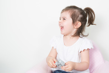 Wall Mural - beautiful little girl playing on the child couch