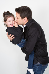 Wall Mural - Father and daughter relations kiss play and smile in studio