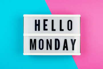 hello monday - text on a display lightbox on blue and pink bright background.