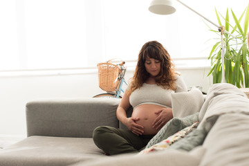 Wall Mural - Pregnant woman touching her belly