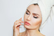 © Sabina_Nasom - Beautiful natural girl woman after cosmetic procedures , face-lift , facial massage , visit a beautician , massage lines. Beautiful woman with a towel on his head. Spa treatments