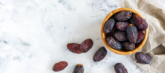 Wall Mural - Delicious dates in a wooden bowl.