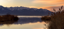 Panorama Of A Lake With Mountains In The Background During The Golden Hour