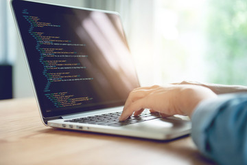 Closeup coding on screen, Woman hands coding html and programming on screen laptop, development web, developer.