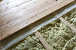© bilanol - Installation of new floor of wooden natural planks and mineral wool insulation for isolation and keeping warmth. Construction, renovation, warm comfortable house concept.
