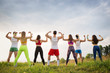 © Evgenia Tiplyashina - Group of sports people on the grass