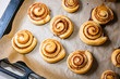© inese.online - Freshly baked cinnamon buns Kanelbule - swedish dessert with spices on parchment paper