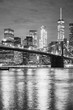 Black and white picture of the Brooklyn Bridge and Manhattan at night, New York City, USA.