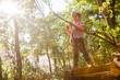 © Aitor Diago - Little boy playing with some sticks in the forest.