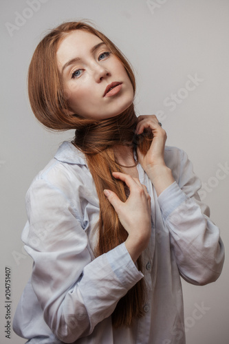 Attractive Redhaired Woman Tying Thick Ginger Long Hair Around