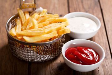 Wall Mural - French fries on wooden table