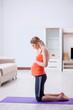 © Elnur - Pregnant woman doing sport exercise at home
