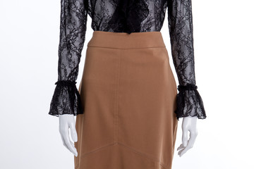 Wall Mural - Close up brown skirt and lace blouse. Female mannequin with cotton skirt and black transparent shirt, cropped image.