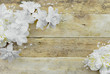 White and ivory silk flowers on a rustic wooden white washed background. Good for wedding or anniversary.Copy space