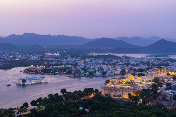 Wall Mural - udaipur city at lake pichola in the evening, rajasthan, india. view from the mountain viewpoint see 