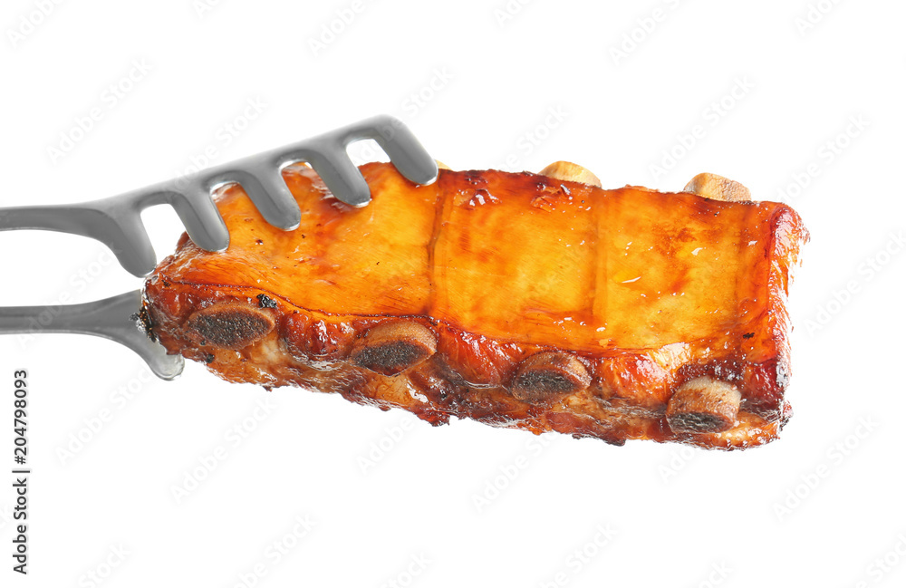 Forceps with delicious grilled ribs on white background