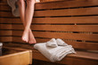 © Africa Studio - Young woman sitting on wooden bench in sauna