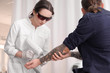© Africa Studio - Cosmetologist with patient and professional tattoo removal laser in salon