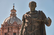 Rome, Bronze statue of emperor Julius Caesar, in the background the dome of  Saints Luca and Martina Church